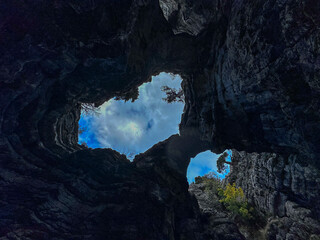 Fototapeta premium Looking at the sky through deep holes in the extraordinary geography of the mountains