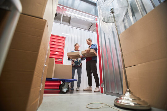 Couple renting unit at self-storage facility to store furniture when moving to another house