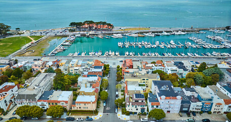 Hotels and apartments beside docked boats at pier in San Francisco harbor aerial, CA