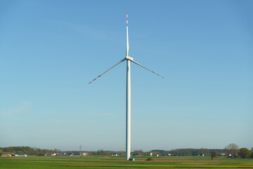 Fototapeta premium Landscape from renewable energy wind turbine with field, forest and sky