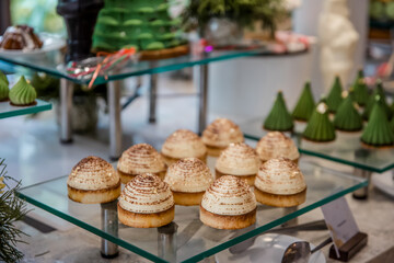 Assortment baked pastry in the buffet. Various different types of sweet cakes, cookies, candies, fruits and other desserts on display. Catering for birthday, wedding, Sunday brunch or other event