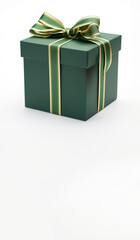 Obraz premium Green gift box - green and gold ribbon - white background - copy space below