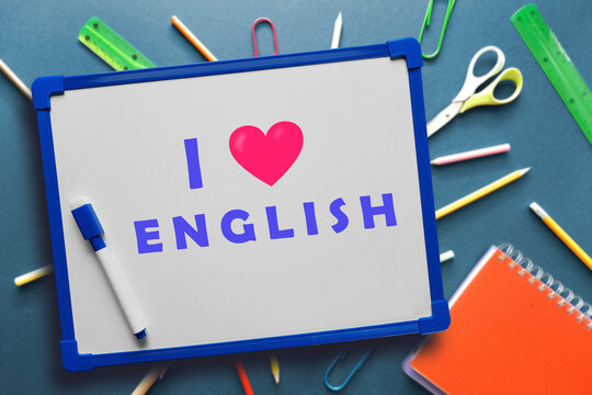 I Like English Written On School Board. White Magnetic Board With Text I Love English On Blue Background With Stationery. Pleasure And Positive Emotions From Studying. Online Language Learning