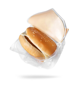 Open plastic package with cheeseburger closeup on a white background