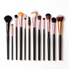 A set of makeup brushes and tools arranged artistically on a white background