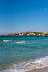 Closeup of sand on beach and blue summer sky. Panoramic beach landscape. Empty tropical beach and seascape