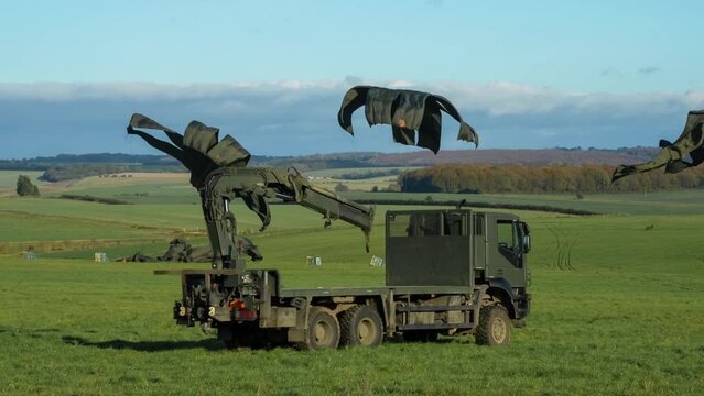 several 1 tonne RAF containerised delivery system (CDS) cargo parachute drops landing and chutes closing 