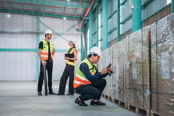 Warehouse worker using barcode scanner in warehouse. Engineer is working and checking the stock at the manufacturing.