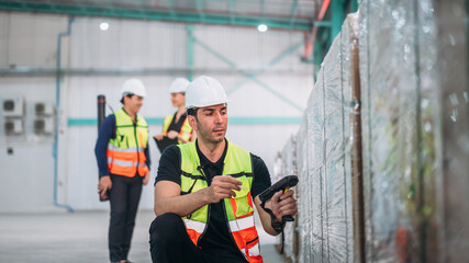 Warehouse worker using barcode scanner in warehouse. Engineer is working and checking the stock at the manufacturing.