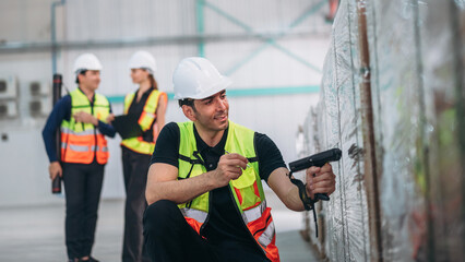 Warehouse worker using barcode scanner in warehouse. Engineer is working and checking the stock at the manufacturing.