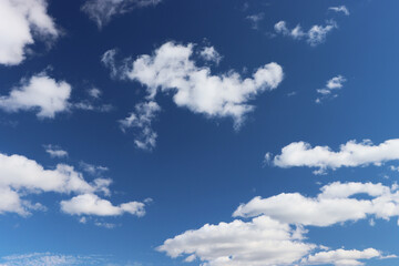 Naklejka na ściany i meble Light gray clouds against a blue sky.