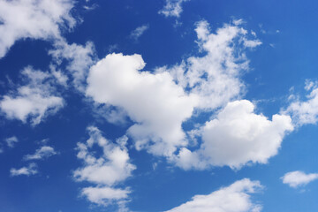 Fototapeta premium Light gray clouds against a blue sky.