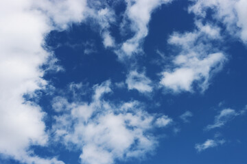 Fototapeta premium Light gray clouds against a blue sky.