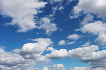 Fototapeta premium Light gray clouds against a blue sky.