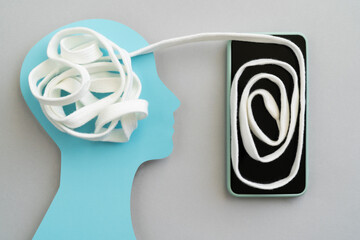 Online therapy concept - tangled white lace gets untangled via phone