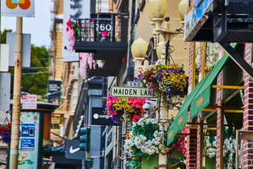 Colorful hanging flowers on Maiden Lane street sign on touristy area of San Francisco, CA