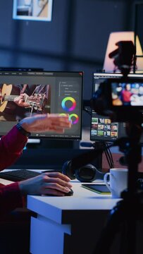 Vertical video Videography content creator recording tutorial using professional camera, talking with audience about elevating video quality with skillful editing techniques. Media production