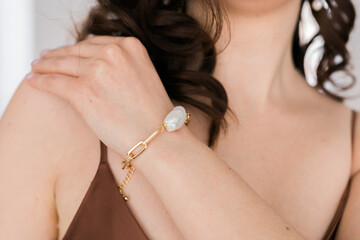 Detail of young woman wearing beautiful luxury earring. Handmade jewellery and accessories