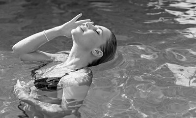 Woman in the pool. Concept of recreation and relaxing. Beautiful lady at weekend taking sunbath