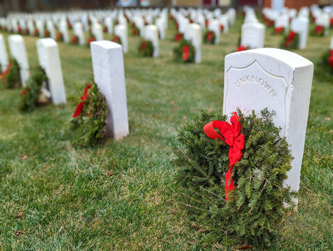 Christmas wreaths on the graves tombs of USA War Veterans in national cemetery, military