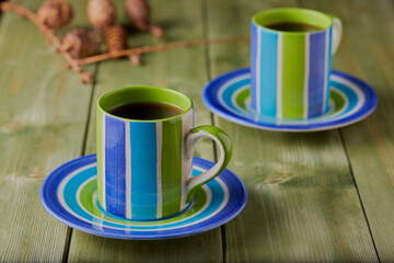 Fresh cups of coffee in a coffee bar with a rustic setting.