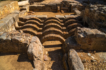 Ruins of the archaeological remains of the ancient thermal baths of a Roman running water and...