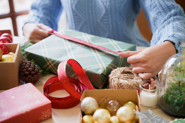 Obraz na płótnie Canvas Woman preparing christmas gift box at home.