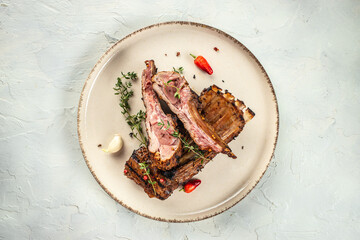 Chops of lamb on bone on a light background top view. copy space - obrazy, fototapety, plakaty