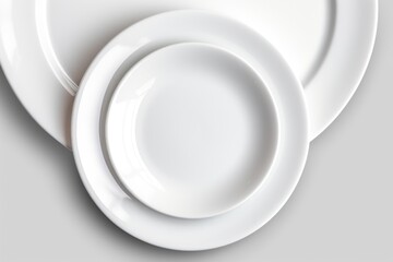 A close-up view of a white plate placed on a table. This versatile image can be used to showcase various dining concepts and food presentations