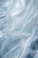 A close-up photograph of a blue plastic bag. This image can be used to illustrate concepts such as recycling, pollution, waste management, or environmental issues