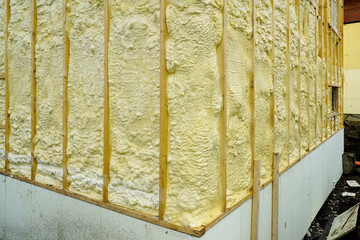 The facade of the residential house sprayed with a layer of polyurethane thermal insulation foam