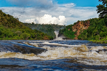 Murchison Falls National Park in Uganda, beautiful water falls on the river Victoria Nile, rainbow...