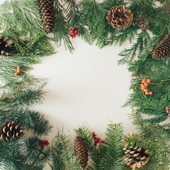 Creative arrangement of Christmas winter foliage and pine cones. Holiday background. Flat lay.