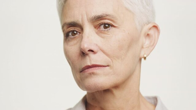Calm Mature Woman Face Close Up Portrait on White Background