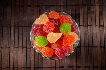 top view glass of fruit jelly with sugar on the dark background 