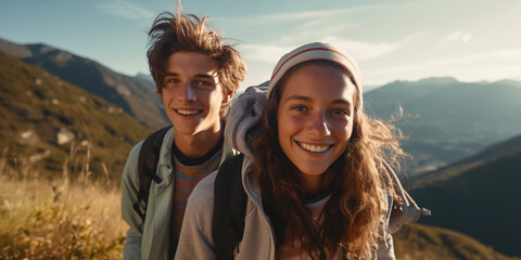 teens boy and girl hiking in the mountains and have fun - obrazy, fototapety, plakaty
