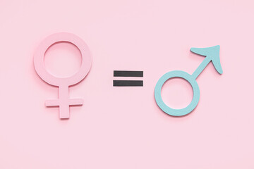 Female and male gender symbols and equal sign on pink background. Gender equality concept