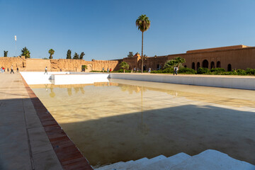 Main courtyard of the El Badi palace in the city of Marrakesh, with some tourists. Sunny day.