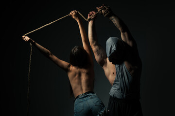 Bdsm, rope hand. Young sexy couple in love embracing and hugging. Love moments for sensual sexy couple. Sensual relationship. Sensual pleasure touching body pleasure.