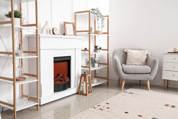 Modern fireplace with shelving units and armchair in living room
