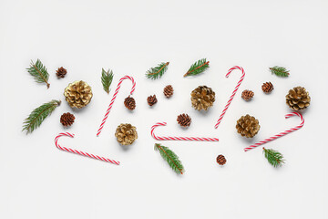 Christmas composition with pine cones, branches and candy canes on white background