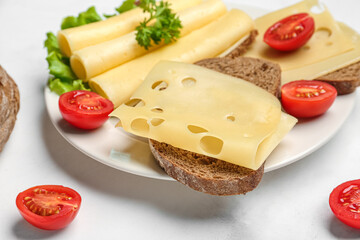 Tasty sandwiches with cheese and tomatoes on light background, closeup