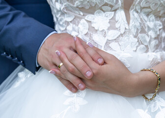 hands with wedding rings. hands of the bride and groom with wedding rings on the background of a...