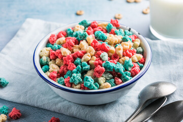 The concept of a healthy breakfast of vegetarian yogurt, whole grain cereal fresh fruit on a blue table against a white kitchen background. Front view.