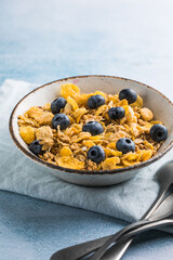 cereal flakes in a blue bowl on white background