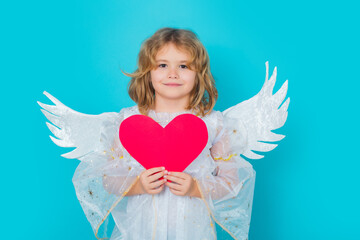 Angel child with heart. Beautiful little angel. Isolated studio shot. Cute Pretty child with angel...