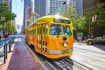 Foto auf Acrylglas Yellow Fishermans Wharf streetcar trolley for F Market with skyscraper buildings San Francisco, CA © Nicholas J. Klein