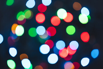 Colourful festive bokeh lights on background. Abstract multicolored light. Christmas or New Year holiday concept. Mock up template for greeting card