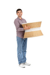 Young man carrying rattan table on white background