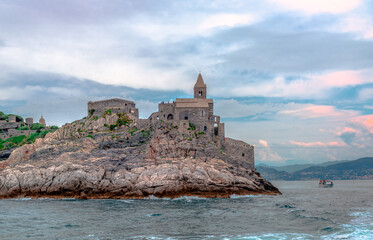 The medieval Roman Catholic Church of San Pierto, peeking out over the promontory in Porto Venere,...